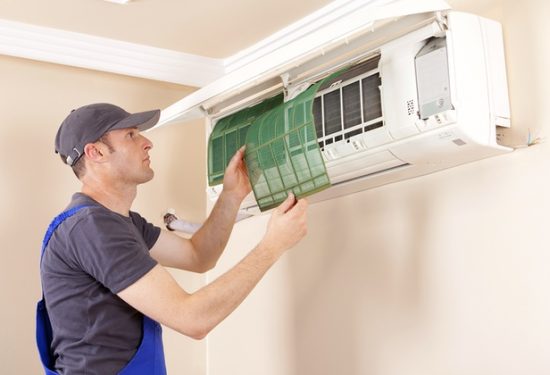 hvac repair technician working on a system